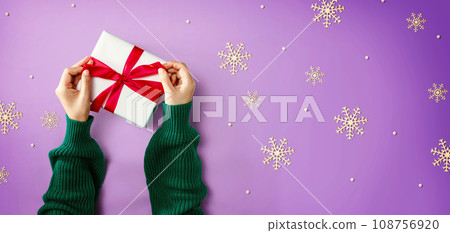 Person making a Christmas gift box Person making a Christmas gift box 108756920