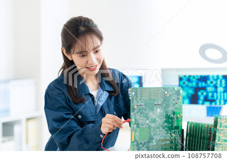 Young female engineer inspecting the board Young female engineer inspecting the board 108757708