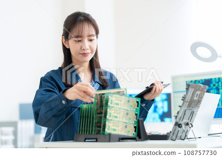 Young female engineer inspecting the board Young female engineer inspecting the board 108757730