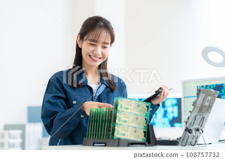 Young female engineer inspecting the board 108757732