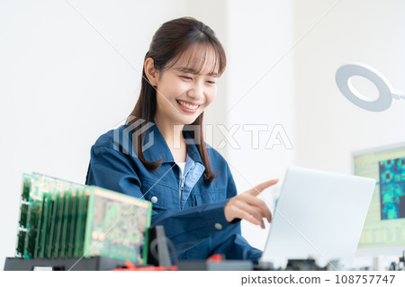 Young female engineer inspecting the board Young female engineer inspecting the board 108757747