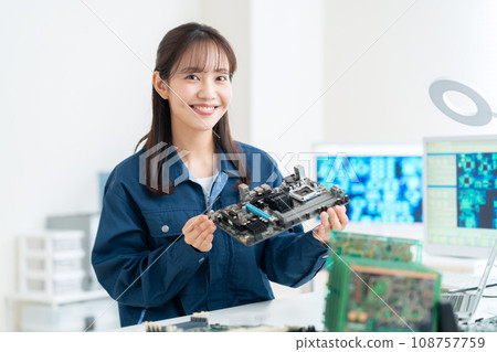 Young female engineer inspecting the board Young female engineer inspecting the board 108757759