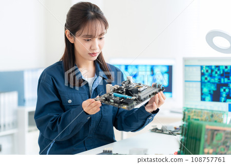 Young female engineer inspecting the board Young female engineer inspecting the board 108757761