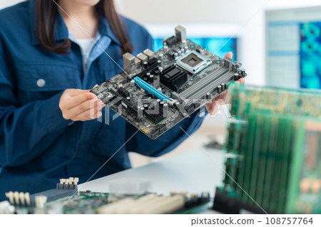 Young female engineer inspecting the board 108757764