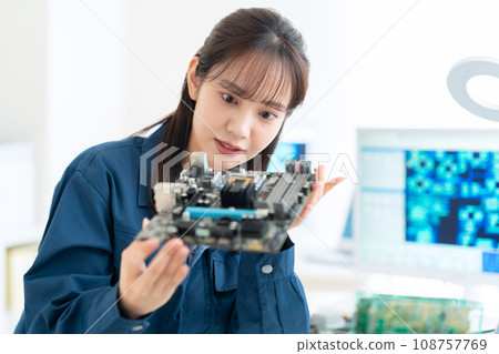 Young female engineer inspecting the board 108757769