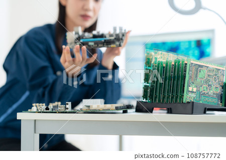 Young female engineer inspecting the board 108757772