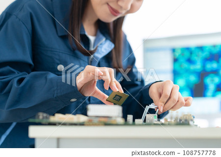 Young female engineer inspecting the board 108757778