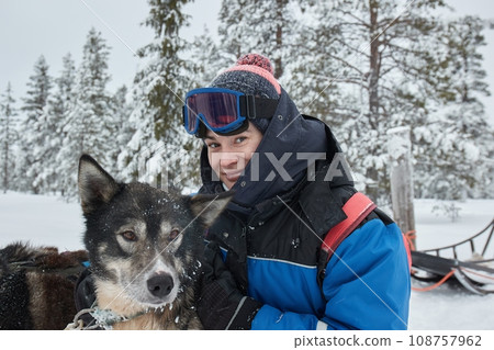 Cute dog playful in the snow Cute dog playful in the snow 108757962