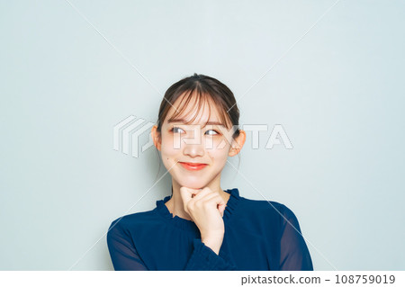 A woman thinking happily A woman thinking happily 108759019
