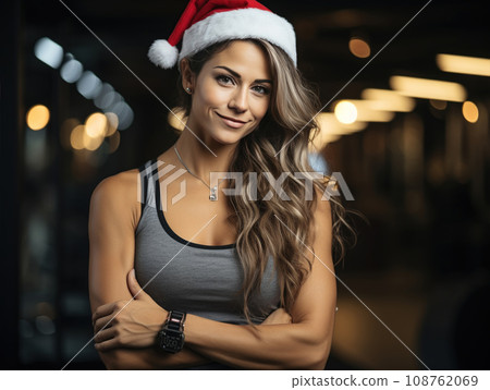 Female Santa Claus fitness trainer. A muscular man in a gym 108762069