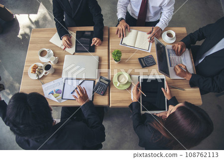 Top view business people meeting together at office desk in conference room. Team business meeting partnership planning brainstorming together. Team Collaborate group of partner company brainstorming 108762113