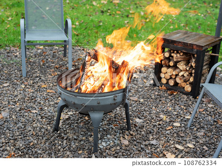 Fire pit and burning fire in a garden 108762334
