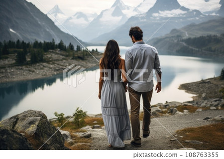 Couple Standing At Top Of Hill On Hike with beautiful lake. Generative AI Couple Standing At Top Of Hill On Hike with beautiful lake. Generative AI 108763355