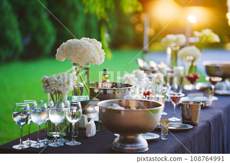 Beautifully set banquet table with black tablecloth. S Beautifully set banquet table with black tablecloth. S 108764991
