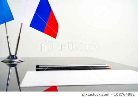 Flag of Russia with pen and blank document on table Flag of Russia with pen and blank document on table 108764992