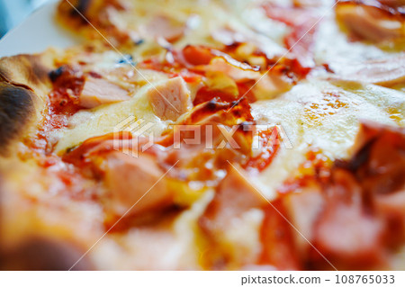 Close-up of cheese with bacon pizza. Close-up of cheese with bacon pizza. 108765033
