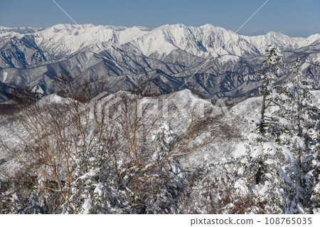 Mt. Tanigawa seen from the mountain trail of Mt. Kengamine in winter Mt. Tanigawa seen from the mountain trail of Mt. Kengamine in winter 108765035