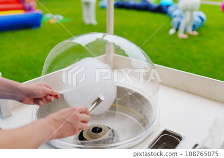 Making cotton candy at a children's party. Making cotton candy at a children's party. 108765075