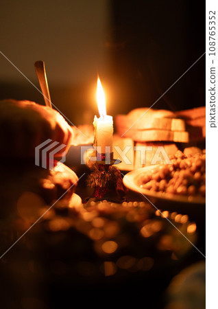 Christmas Eve in a Ukrainian family. Kutia on the table and a lighted candle. 108765352