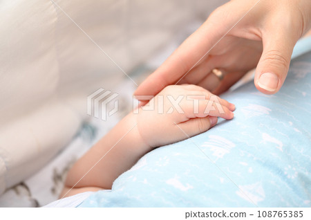 Close-up of a newborn baby's small hand. Close-up of a newborn baby's small hand. 108765385