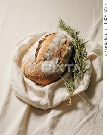 Freshly baked bread on rustic wooden table, homemade crisp bread Freshly baked bread on rustic wooden table, homemade crisp bread 108766239
