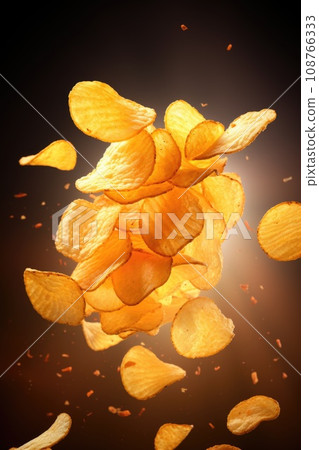 flying potato chips on a dark background with species 108766333