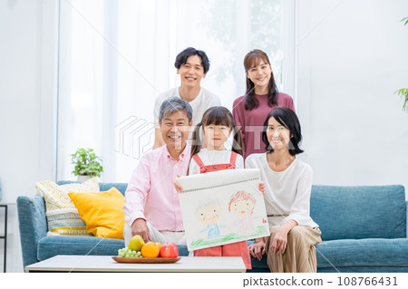 Three-generation family relaxing in the living room Three-generation family relaxing in the living room 108766431