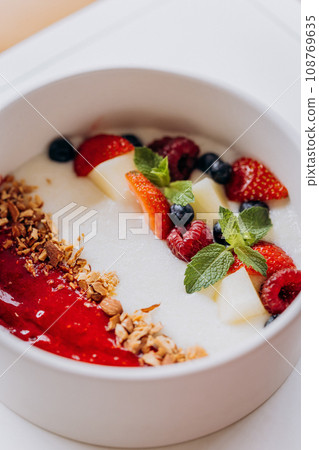 Sweet milk semolina porridge with strawberries on beautiful plate. Delicious breakfast for children 108769635