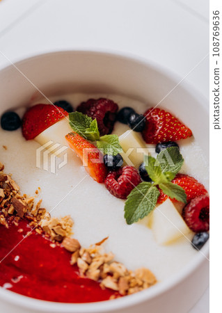 Sweet milk semolina porridge with strawberries on beautiful plate. Delicious breakfast for children 108769636