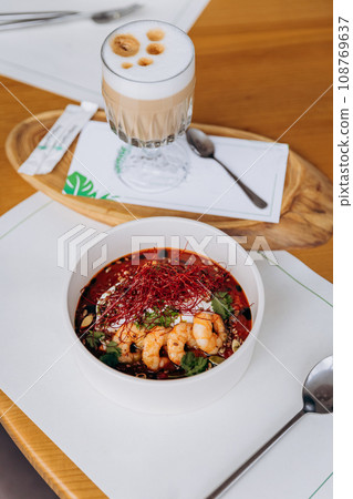 Appetizing Thai food of pumpkin porridge with shrimps served with greens and seeds in restaurant 108769637