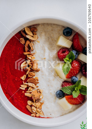 Sweet milk semolina porridge with strawberries on beautiful plate. Delicious breakfast for children Sweet milk semolina porridge with strawberries on beautiful plate. Delicious breakfast for children 108769640