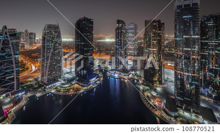Tall residential buildings at JLT aerial night timelapse, part of the Dubai multi commodities centre mixed-use district. 108770521