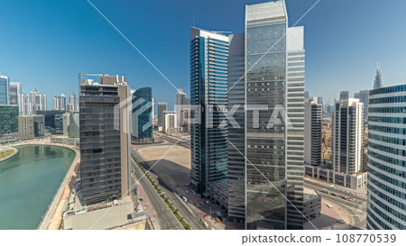 Cityscape skyscrapers of Dubai Business Bay with water canal aerial timelapse. Cityscape skyscrapers of Dubai Business Bay with water canal aerial timelapse. 108770539