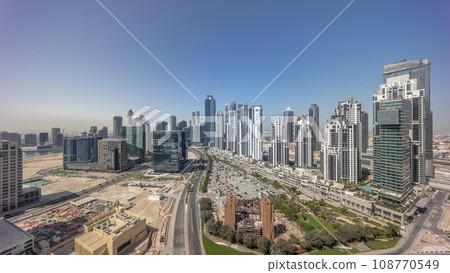Panorama of Bay Avenue with modern towers residential development in Business Bay aerial all day timelapse 108770549