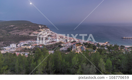 Aerial view of the coastline of the village of Sesimbra day to night timelapse. Portugal 108770659