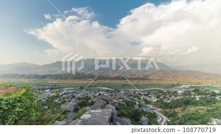 Panorama showing Gjirokastra city from the viewpoint of the fortress of the Ottoman castle of Gjirokaster timelapse. 108770719