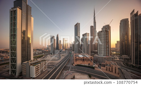Aerial view of Dubai Downtown skyline during sunrise with many towers timelapse. 108770754