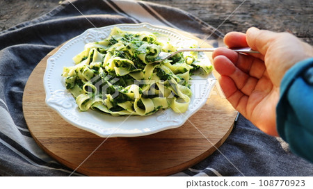 Tagliatelle pasta with spinach , pesto. Top view 108770923