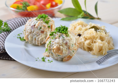 Homemade South Tyrolean bacon dumplings with sauerkraut 108772243