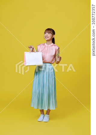 Excited smile Asian woman looking mobile phone holding shopping bag show credit card payment banking shopping online Excited smile Asian woman looking mobile phone holding shopping bag show credit card payment banking shopping online 108772357