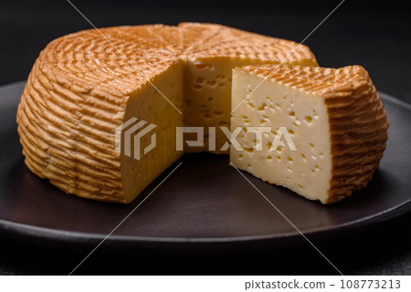 Delicious hard craft cheese made from cow or goat milk 108773213