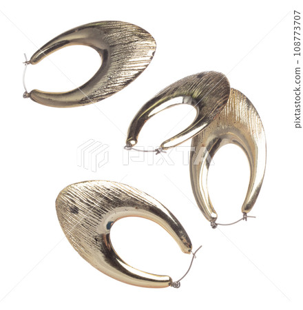 Fashion gold Earrings with beautiful work detail is value. Luxury golden earring is fashion trend and fly in air. White background isolated Fashion gold Earrings with beautiful work detail is value. Luxury golden earring is fashion trend and fly in air. White background isolated 108773707