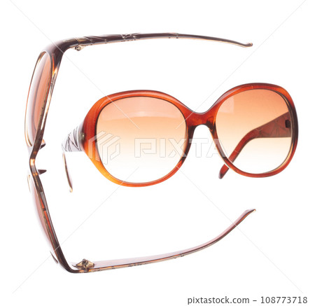 Brown lady sun Fashion Glasses fly in air showing many angle rotated. Fashion trend glasses for confident work and beautiful wearing is good for shape of head. White background isolated 108773718