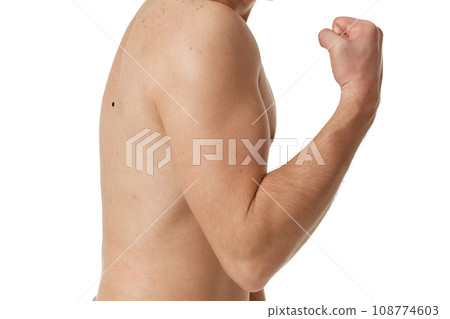 young man showing his bicep over white background. perfect body shape young man showing his bicep over white background. perfect body shape 108774603