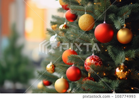 New Year background with copy space. Branches of green Christmas tree decorated with red and golden balls and glowing lanterns. Close up. Blurred background. Merry Christmas. Holiday interior. Card, 108774993