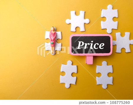 White puzzle and miniature people with text Price on a yellow background. White puzzle and miniature people with text Price on a yellow background. 108775260
