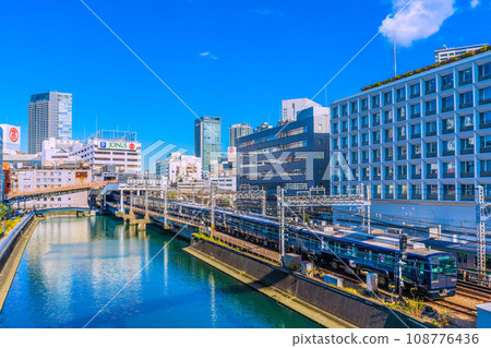 Yokohama cityscape in Japan View of Sotetsu Line Yokohama Station and trains entering the station. You can also see Yokohama Takashimaya and Sogo Yokohama store. 108776436