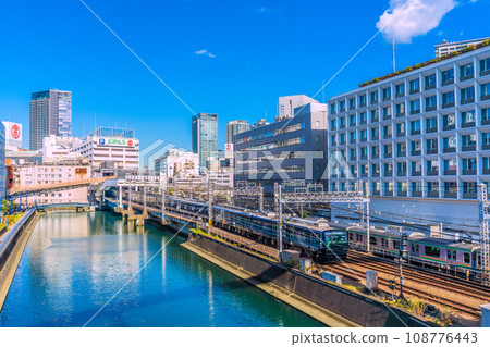 Yokohama cityscape in Japan View of Sotetsu Line Yokohama Station and trains entering the station. You can also see Yokohama Takashimaya and Sogo Yokohama store. 108776443