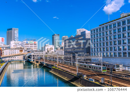Yokohama cityscape in Japan View of Sotetsu Line Yokohama Station and trains entering the station. You can also see Yokohama Takashimaya and Sogo Yokohama store. 108776444