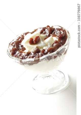 A photo of plenty of red bean paste and almond tofu served in a dessert cup against a white background A photo of plenty of red bean paste and almond tofu served in a dessert cup against a white background 108776667